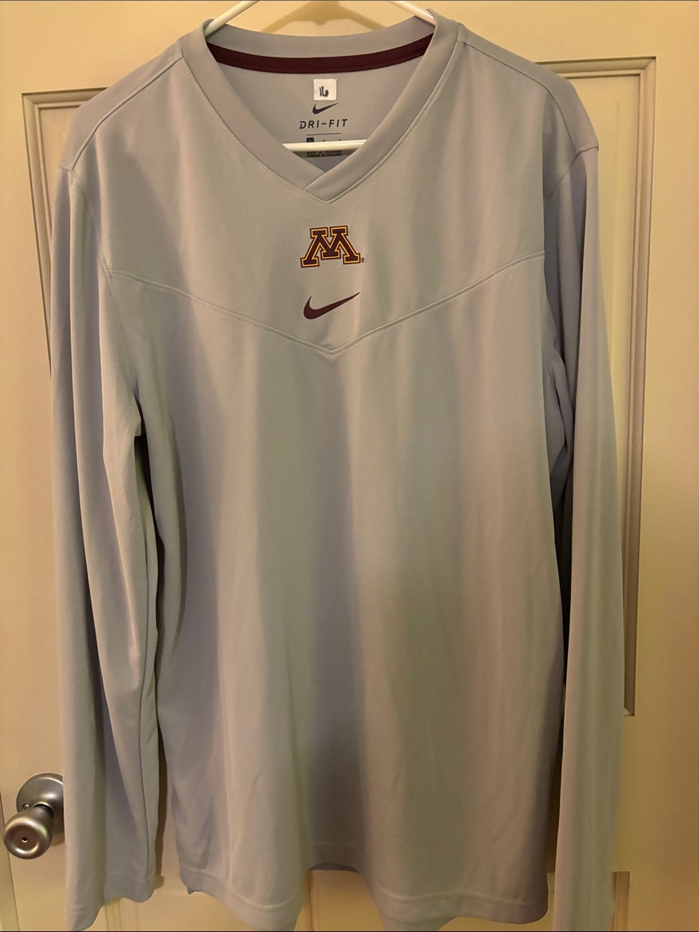 Nike Dri-FIT Minnesota Golden Gophers long-sleeve V-neck shirt featuring the int